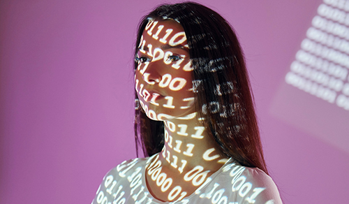 Photo showing a woman with binary projected over her face