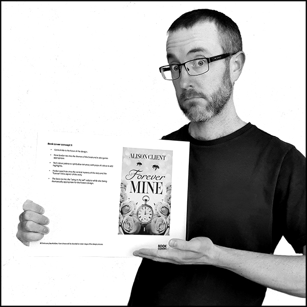 Photo of Jon Stubbington holding a mockup of a cover with explanatory notes next to it.
